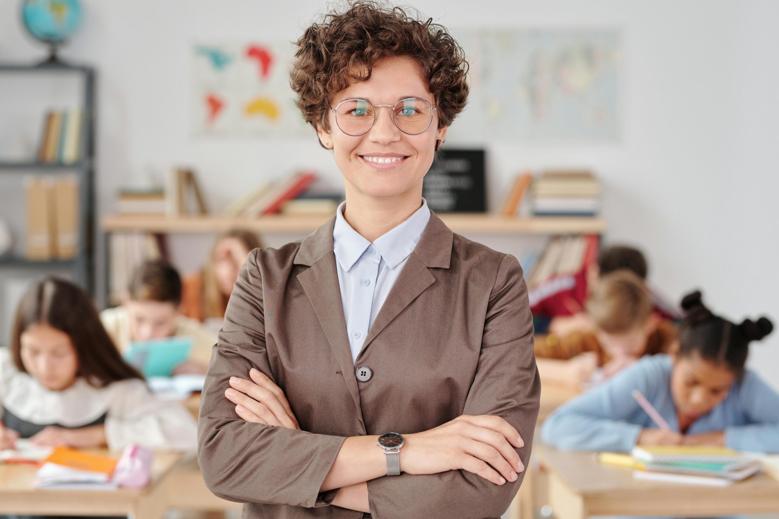 Adult female teacher in classroom, representing education and training providor, HRD Services.